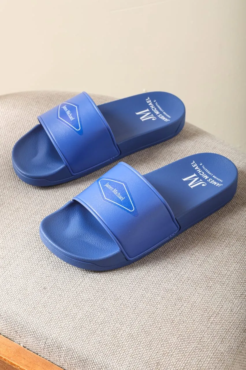 Slippers — Blue — Cushioned slide, badge strap print. (placeholder photography)