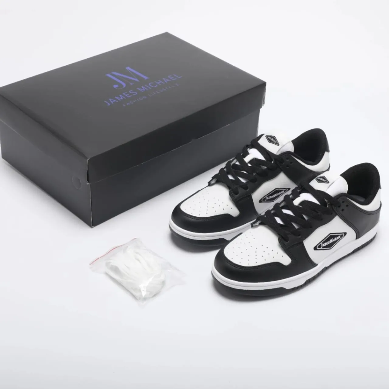 Signature Sneaker — Low-top leather sneaker, boxed. (placeholder photography)